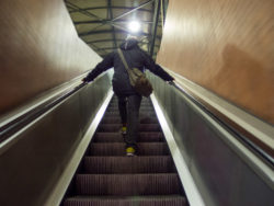 Man On Escalator In Tube