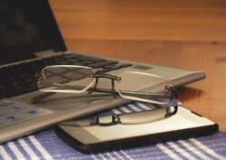 Glasses, Laptop And Phone On The Office Desk