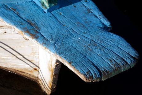 White and blue wooden boat with wood texture