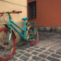 Old bright colored bicycle on the old street