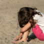 Small sad girl on the beach