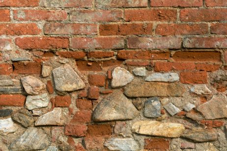 Texture of old wall from orange bricks and stones