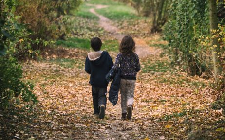 Children Walking Away on the Forest Path
