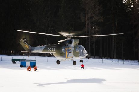 A Military Helicopter Lands in the Snow